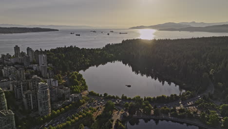 vancouver bc canada aerial v49 drone flyover west end residential neighborhood capturing stanely park, lost lagoon and sun reflecting on english bay - shot with mavic 3 pro cine - july 2023