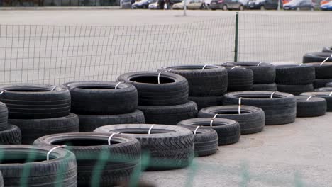 stacked tires behind green netting