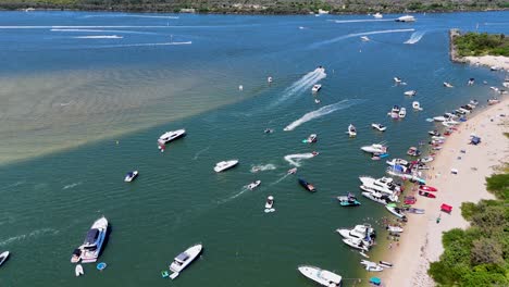 boats and people gather for festive beach event