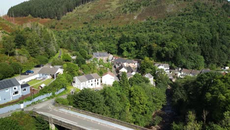 A-backwards-aerial-drone-shot-of-a-bridge-in-a-small-Welsh-village