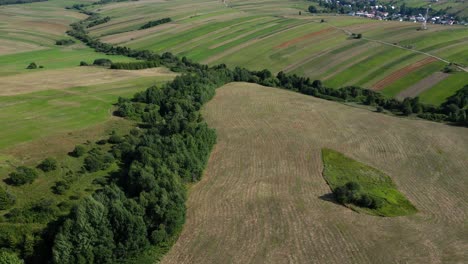 slow cinematic drone tilt up over rolling fields in natural scenery in europe