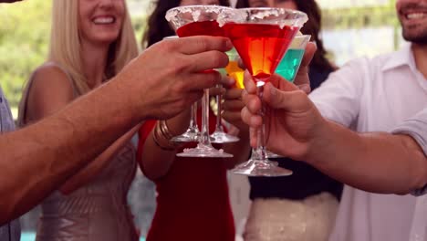 group of friends toasting with cocktail