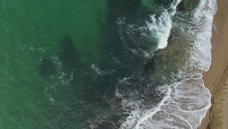 waves breaking into the sea beach