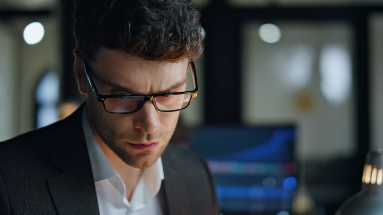 Late businessman using smartphone in office closeup. Focused man trader checking