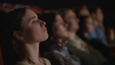 girl watching movie at cinema. girl sitting in theater and watching performance