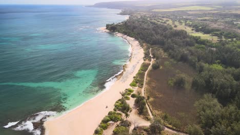 aerial-view-following-the-coastline-of-police-beach-on-oahu-hawaii