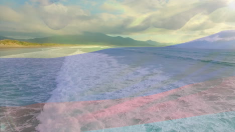 animación de la bandera de colombia ondeando sobre el paisaje marino de la playa