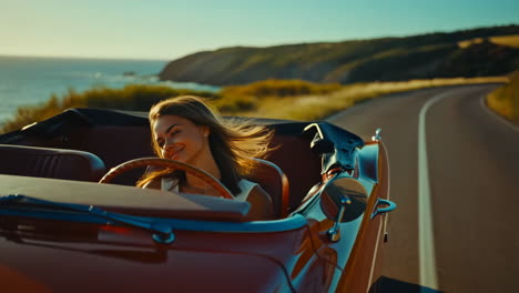 woman driving a classic convertible along the coast