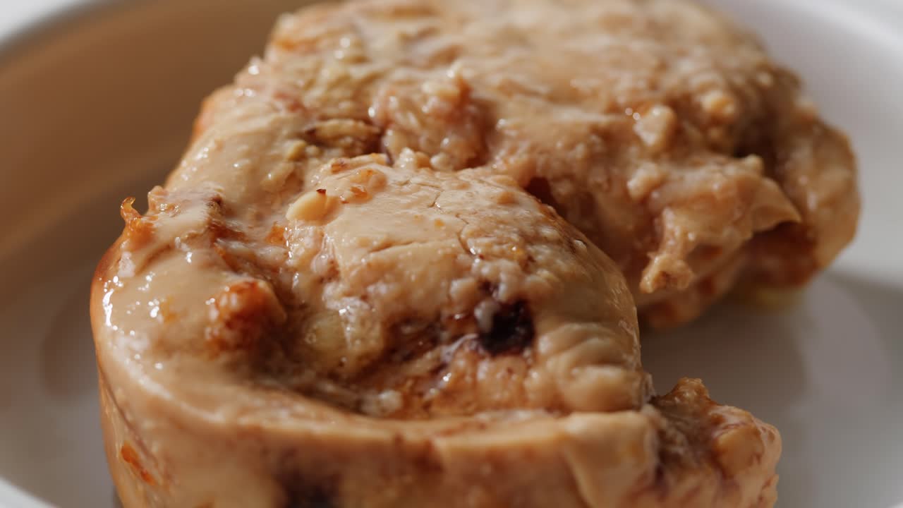 Smoked cod liver in oil in open tin can with fresh greens on wooden table. Seafoods delicacy. High quality 4k footage