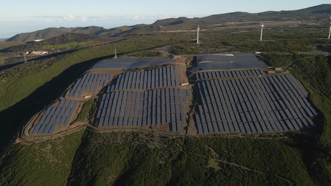 vista aérea de una granja fotovoltaica y una granja eólica en la cima de una montaña en la isla de paul da serra madeira