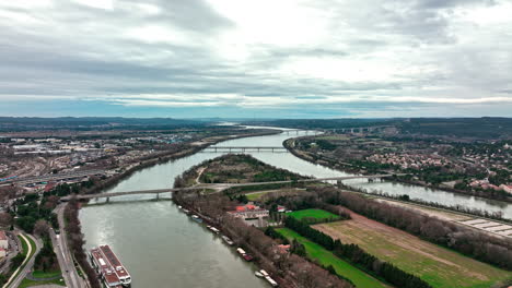 Bird's-eye-perspective-of-Avignon's-landmarks,-mirrored-in-the-Rhône's-waters.