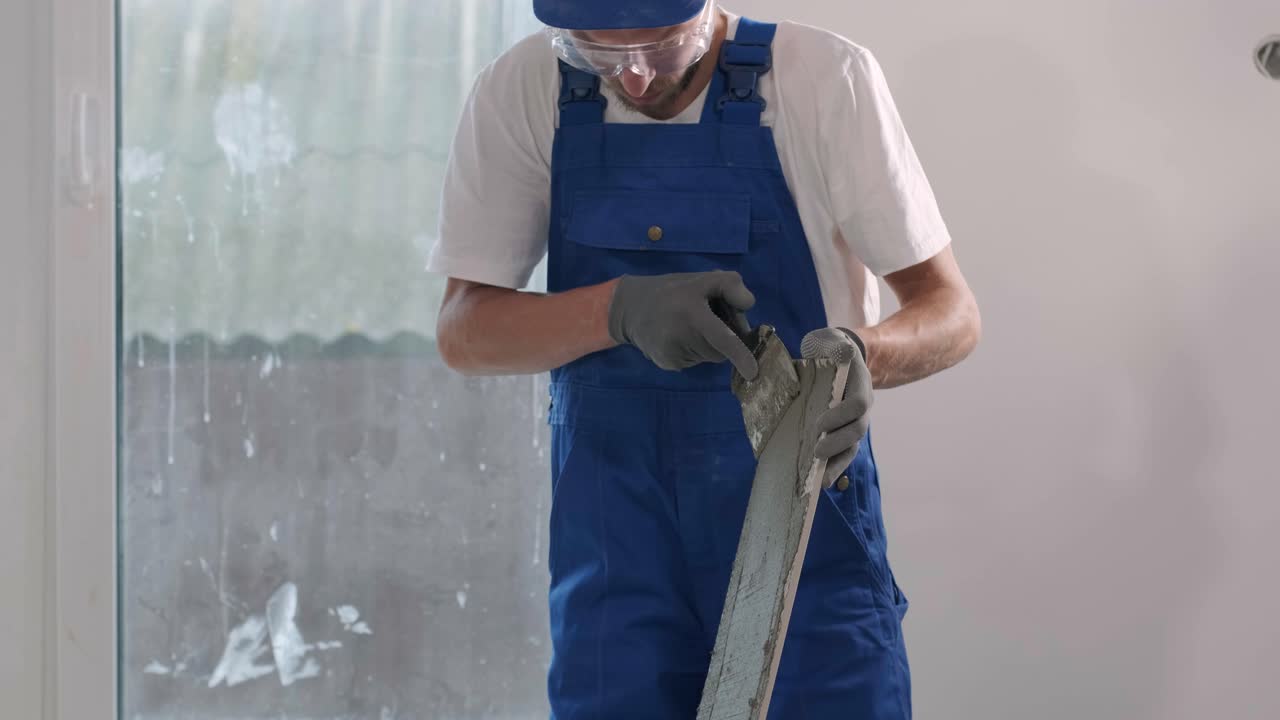 Installing ceramic floor tiles - measuring and cutting the pieces. Construction, renovation, repair apartment. Cuts tile. Tile cutting
