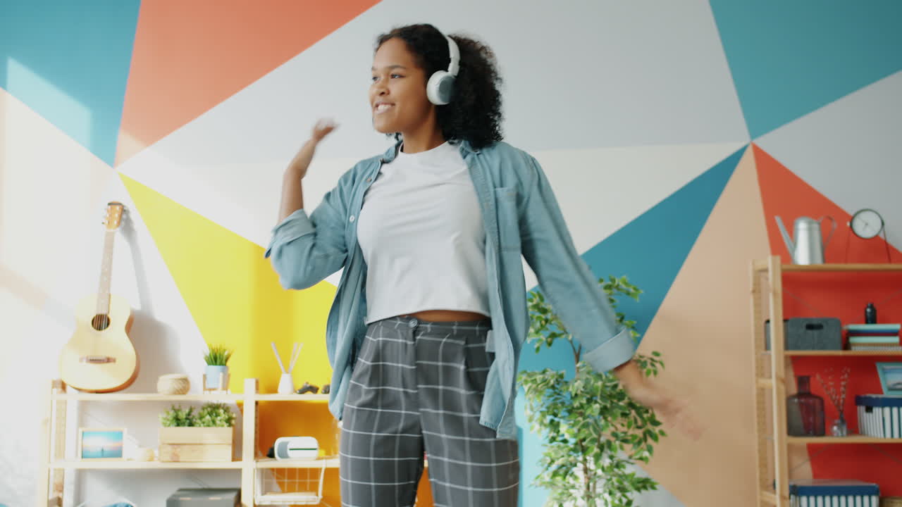 Teenager dancing to music at home