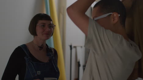 female director and film crew watching male actor shooting movie or video in studio on monitor