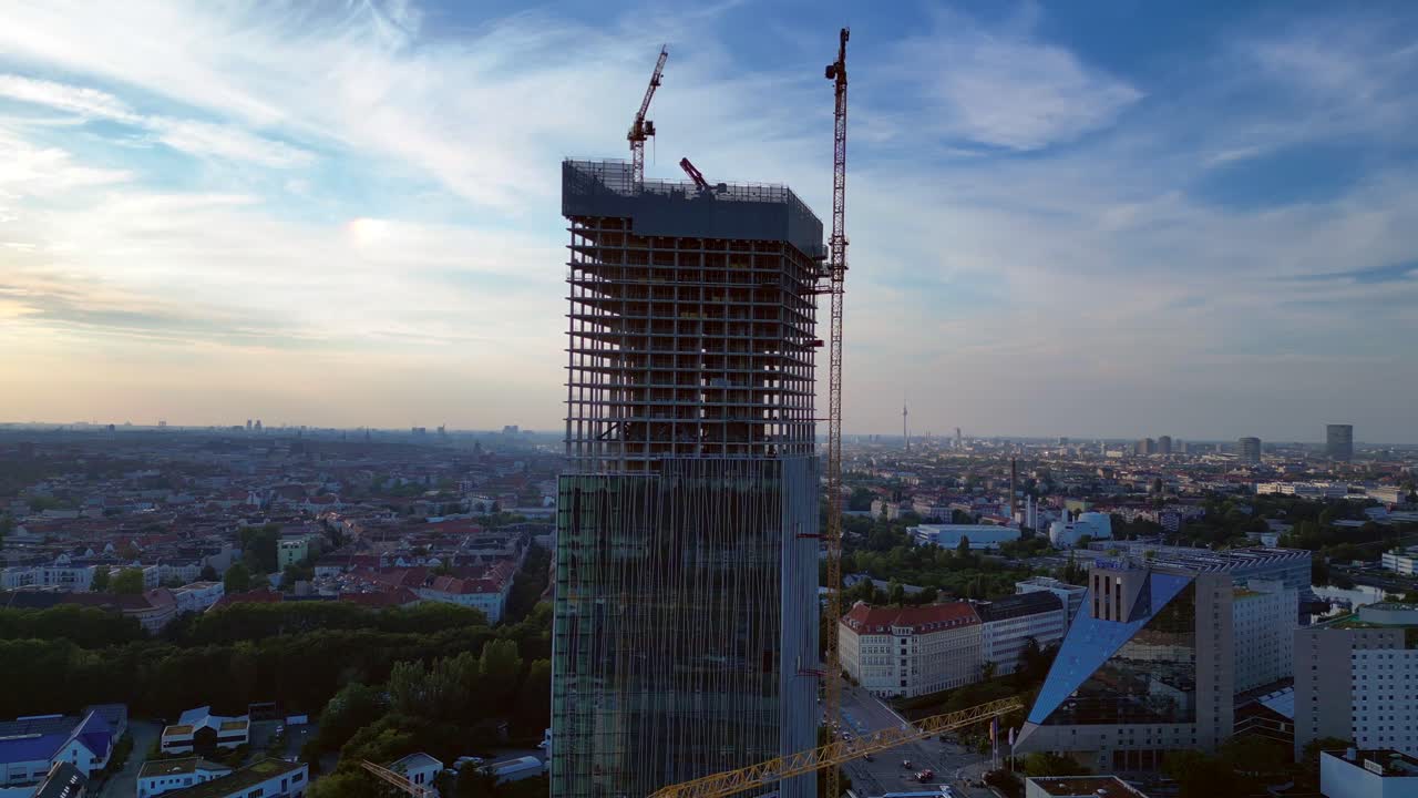 Construction site of the estrel tower in berlin 2024, with cranes and cityscape in the background. Perfect aerial view flight speed ramp hyper motion time lapse