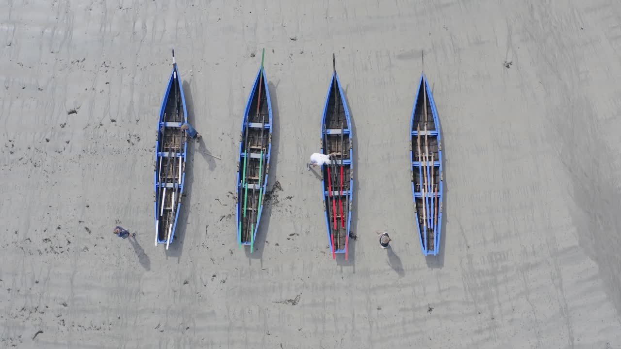 Top down bird's eye view aerial of traditional irish boats, currachs on sandy beach