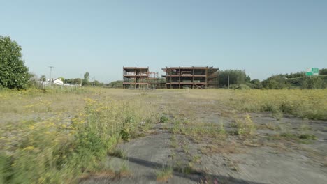 drone entering gate towards incomplete half-built hospital building outside tullamore in offaly county, ireland