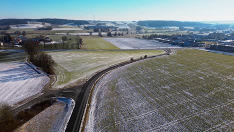 Curved-Country-Road-Beside-Frosted-Winter-Fields-at-Sunrise