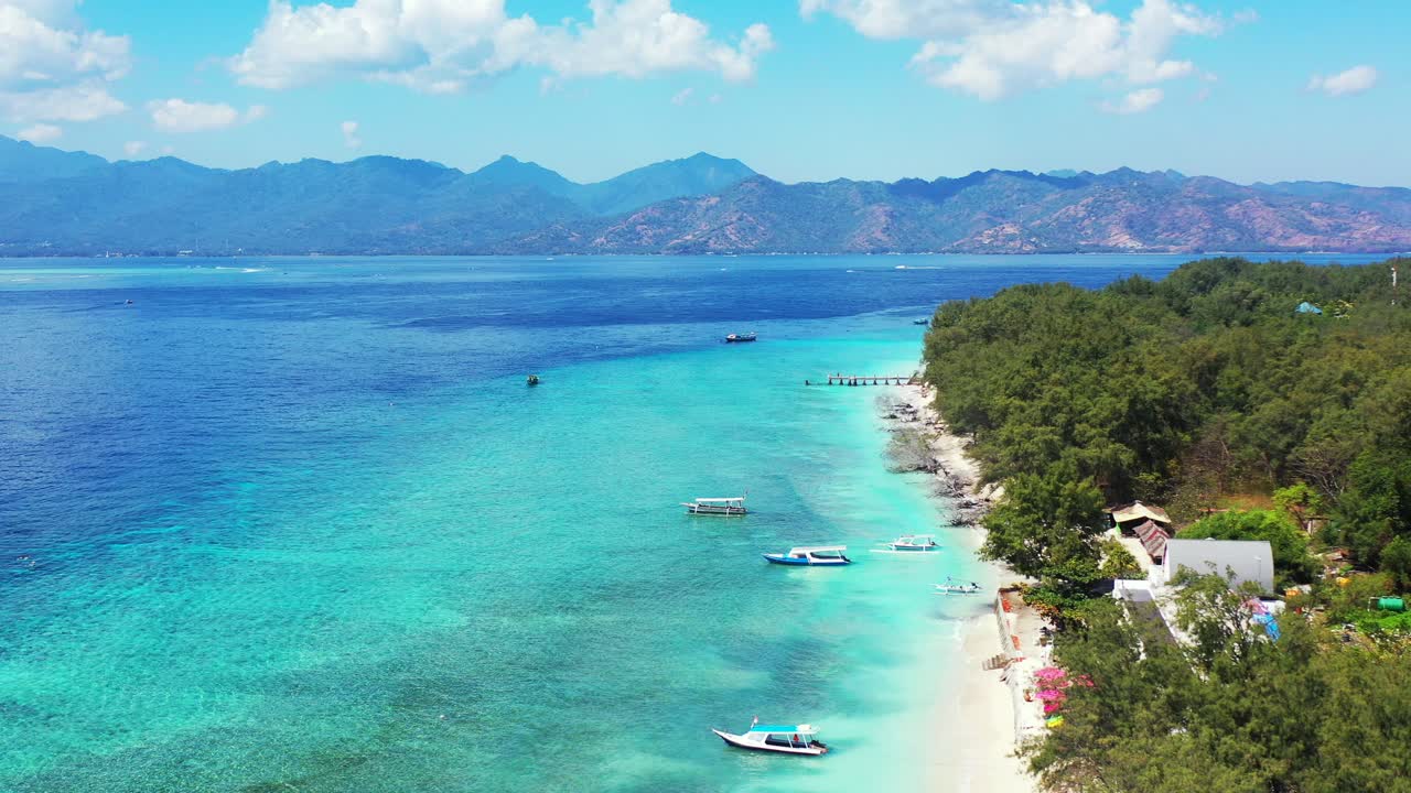 무성한 초목이 있는 휴가 목적지 열대 섬, 인도네시아의 잔잔한 청록색 석호로 씻겨진 모래 해변