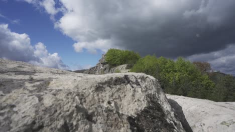 ascending drone shot of the mysterious massif of belintash, the cult site of the ancient thracians in bulgaria