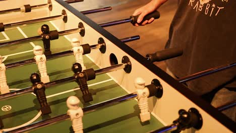 players engaged in a foosball match