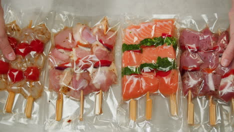 preparing various meat skewers in vacuum sealed packaging