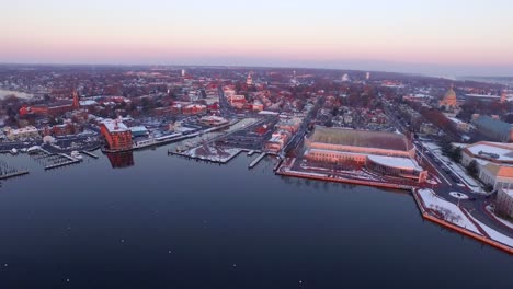 ultra wide aerial shot of purple annapolis harbor at dawn with boat moorings in the water