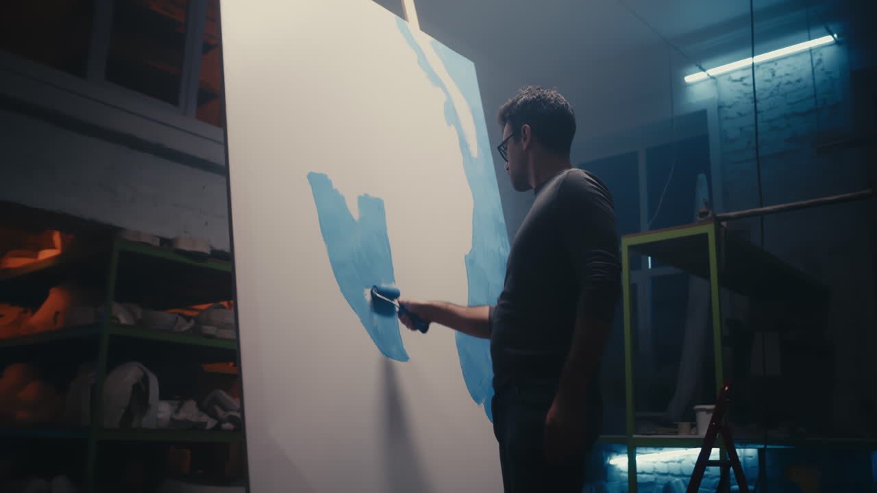 Artist Painting on Canvas in Studio