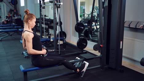 Sporty woman is doing an exercise to strengthen the shoulder girdle, muscles of the back, arms and legs in a fitness club. Healthy lifestyle.