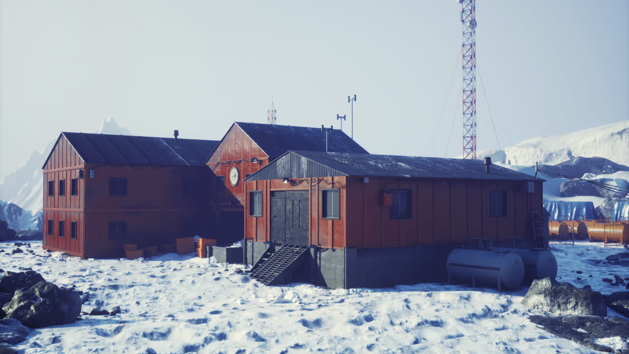 Research facility located in a snowy antarctic landscape during winter daylight