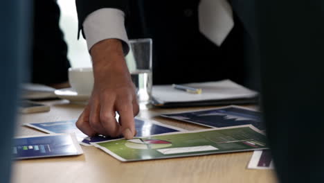 business people looking at graphics
