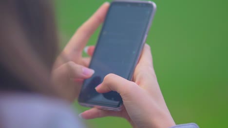 Woman's-Hand-Typing-Message-On-Cellphone