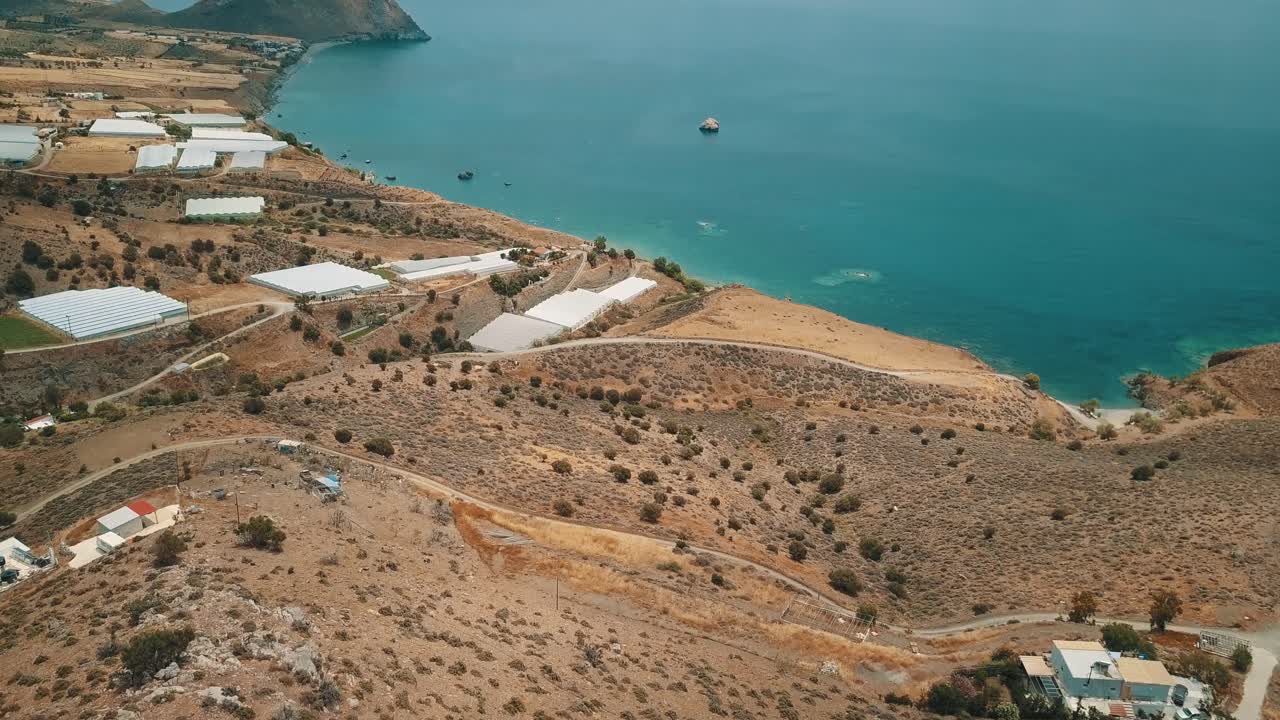 Aerial shot of the south coast of Crete with turquoise waters and beautiful arid scenery.