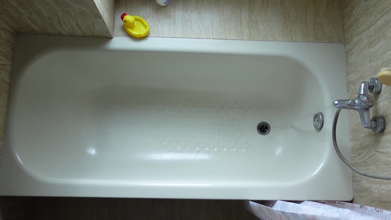 Acqua che scorre in una vasca da bagno vuota da una vista dall'alto