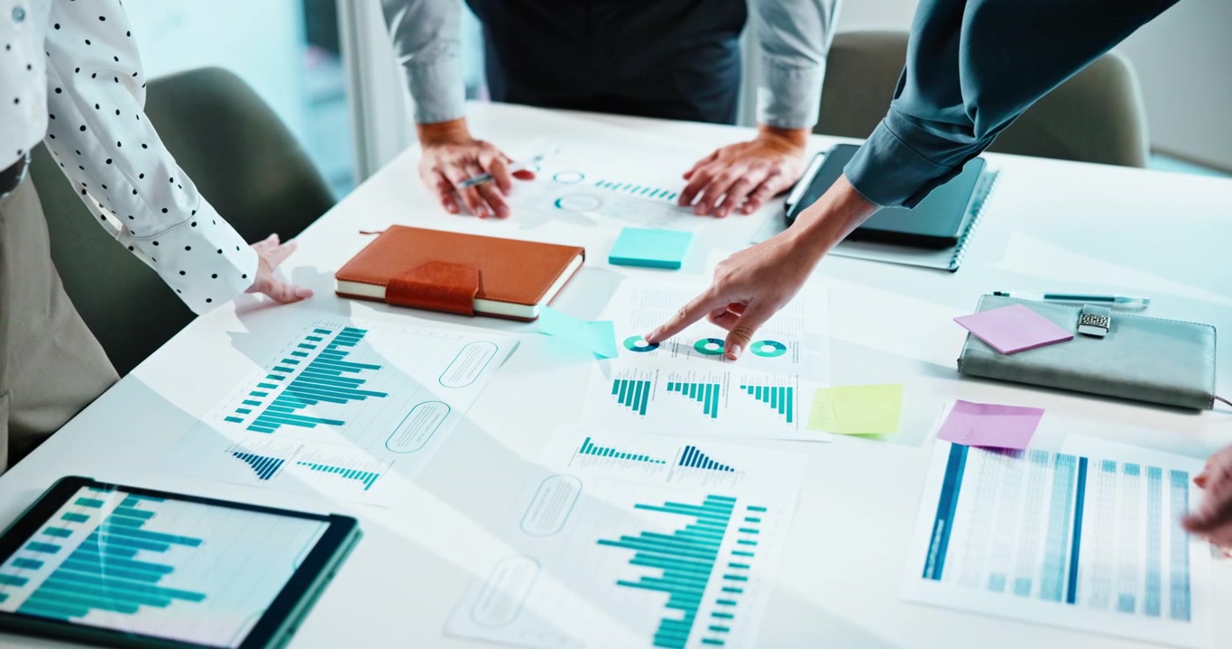 Business Team Analyzing Financial Charts and Data in Office Meeting
