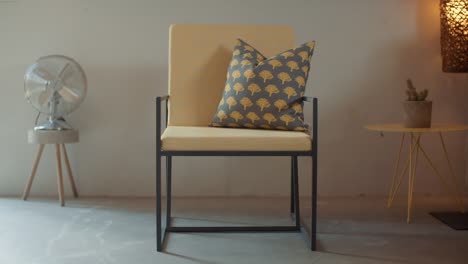 slide on chair decorated with bespoke textiled yeallow cushions and and a pillow