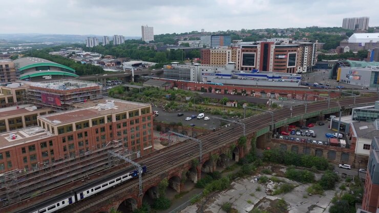 Train Crosses a Historic Brick Viaduct with Modern Newcastle City Behind, England