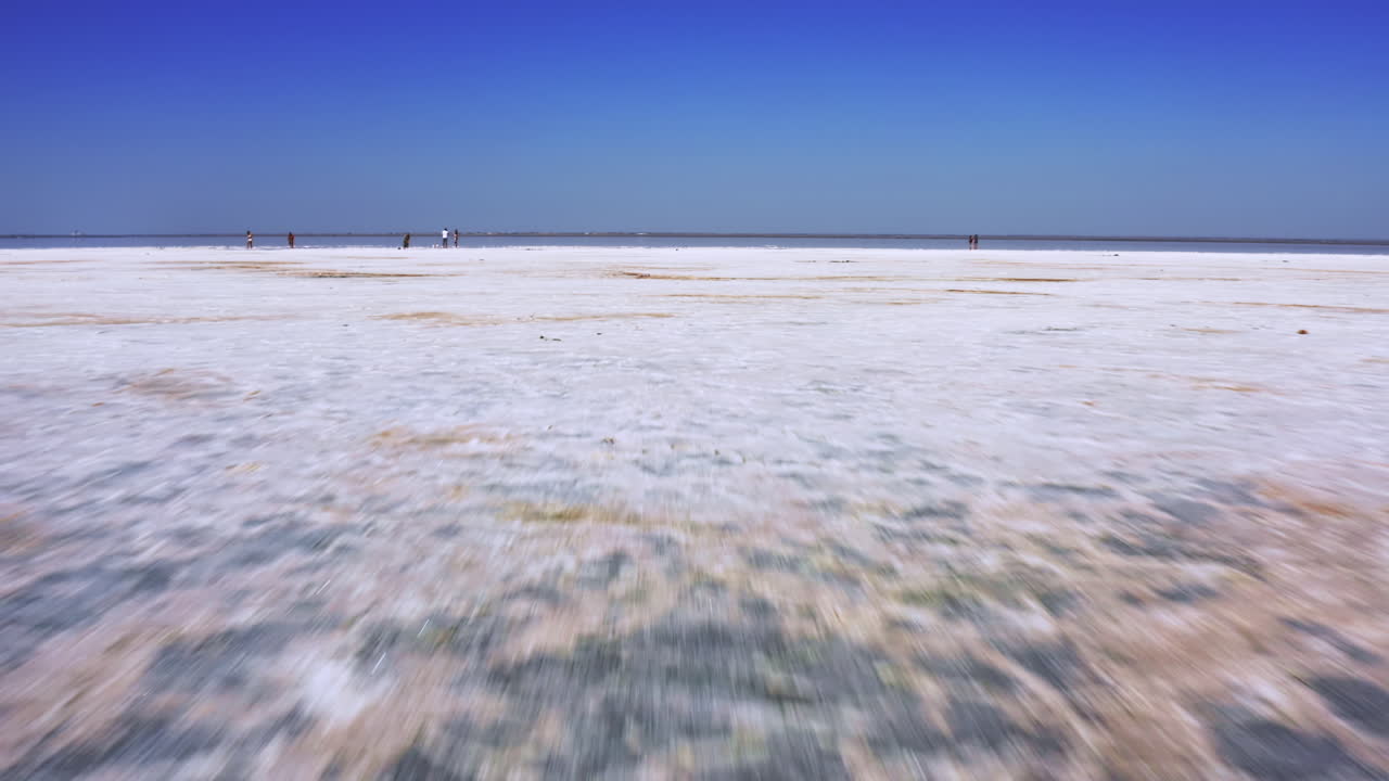 Fast aerial travel over white salt flats.