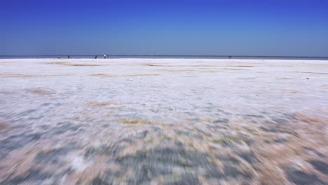fast aerial travel over white salt flats.