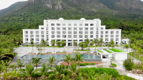 breathtaking white building of orson hotel and resort surrounded by lush greenery in con dao, vietnam