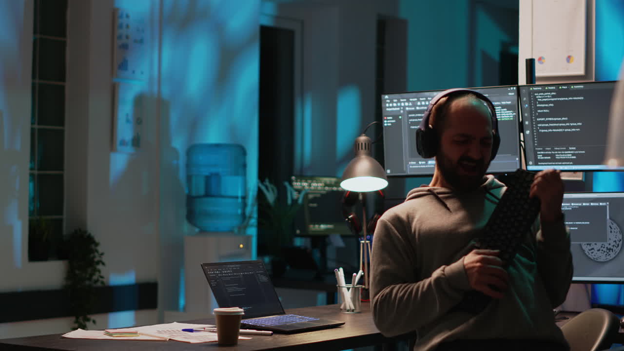Man playing air guitar with keyboard in office
