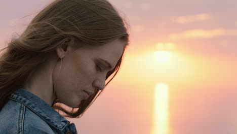 portrait of beautiful young woman enjoying peaceful seaside at sunset exploring spirituality contemplating future