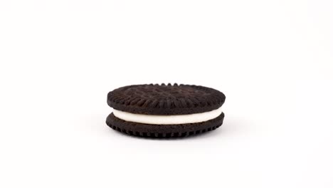 two chocolate wafers separated by a cream filling cookie isolated on white background. rotating on a turn table. loopable. popular vegan dessert.