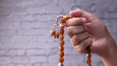 hand holding prayer beads