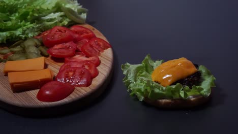 carefully putting freshly cooked beef meat cutlets with spatula aside vegetables