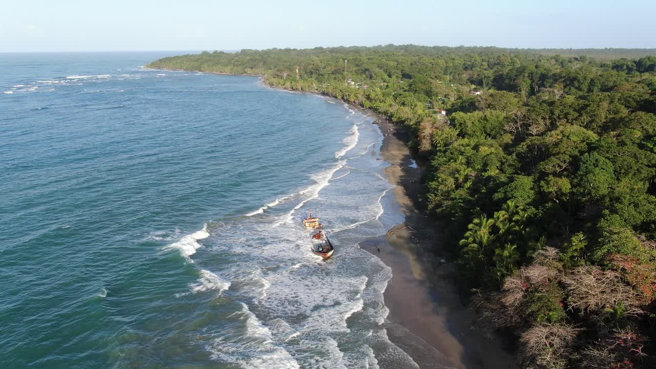 Costa Rica beach drone view showing sea, shore and a stranded ship on a sunny day over the atlantic ocean in the caribbean