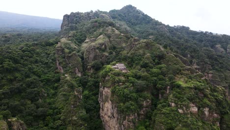Backward aerial drone revealing shot of El Tepozteco in Morelos, Mexico. Pueblo Magico
