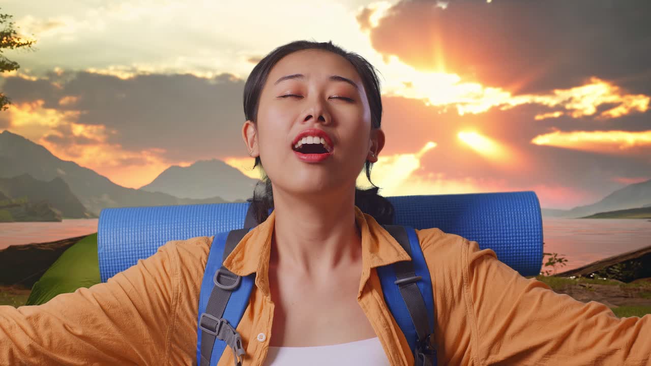 Woman enjoying a peaceful moment during a camping trip at sunset.
