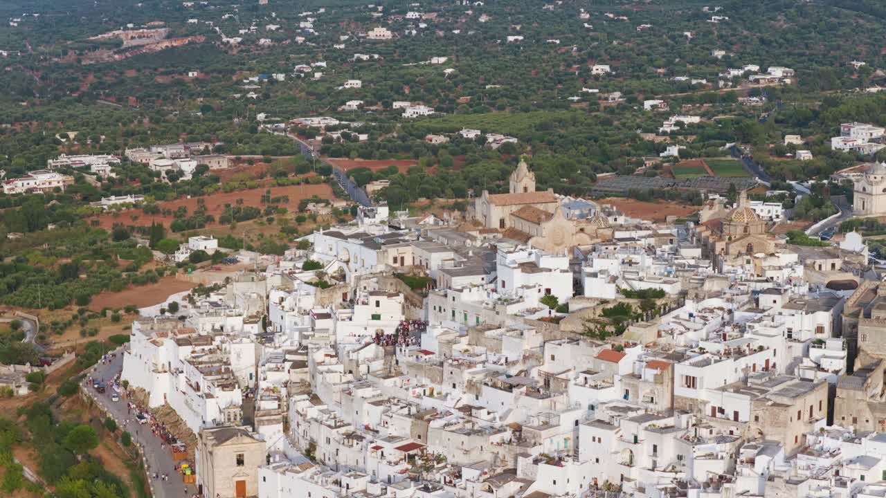 Historic white city of Ostuni, Italy rising aerial wide shot, Italian travel destination
