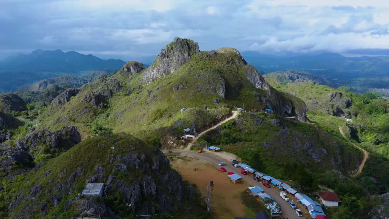 Aerial over Big and Giant Jesus Statue Standing above the city of Toraja Makale